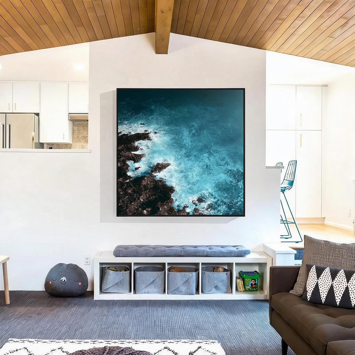 Blue ocean wave abstract painting with black frame displayed in a modern living room