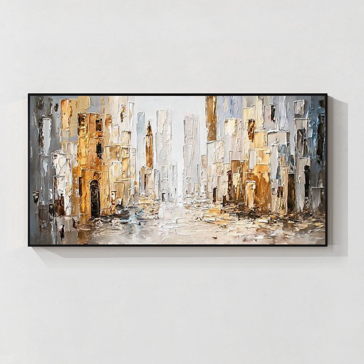 Abstract cityscape wall art with black frame featuring textured buildings in white, gray and gold