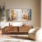 Abstract cityscape wall art with gold frame displayed above a wooden console in a modern living room