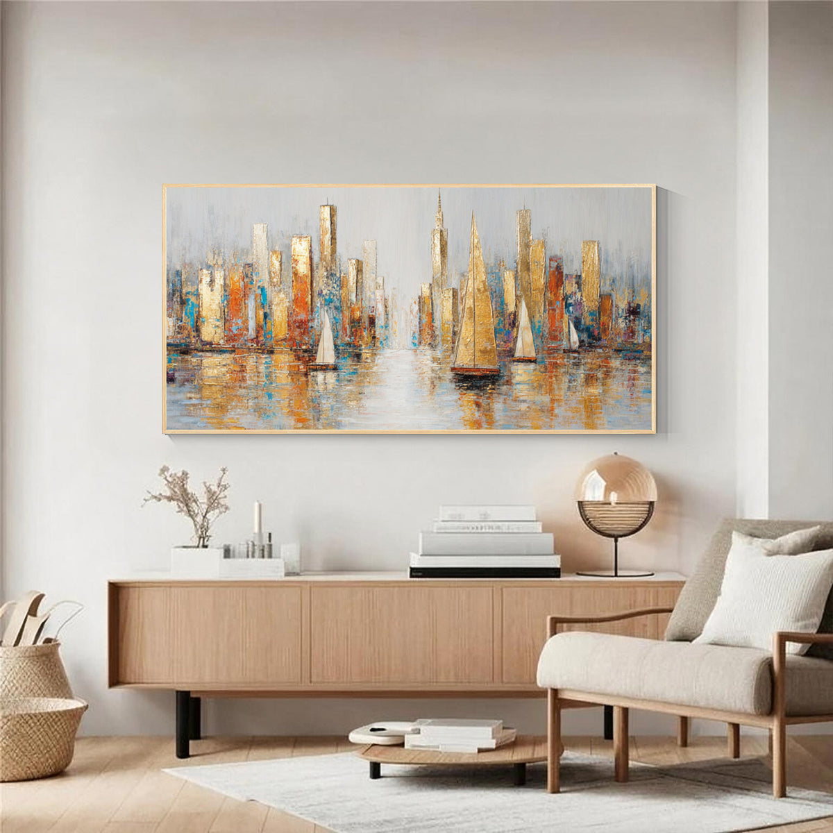 Abstract cityscape and sailboat wall art with gold frame displayed above a wooden console in a modern living room