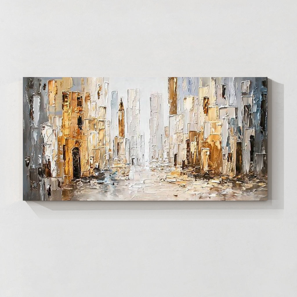 Abstract cityscape wall art featuring textured buildings in white, gray and gold tones