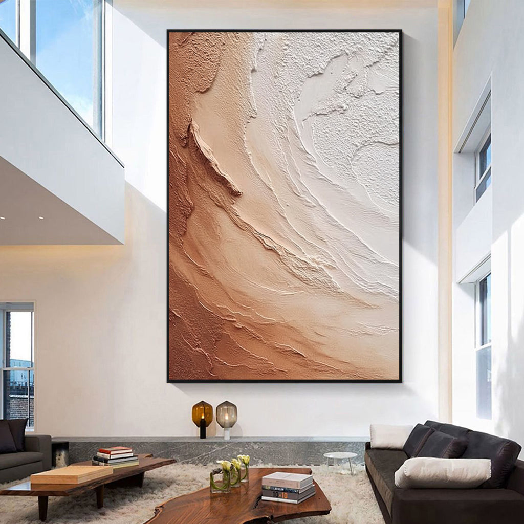 Large beige and brown textured abstract wall art with black frame displayed in a modern living room, featuring layered organic patterns and minimalist contemporary interior design