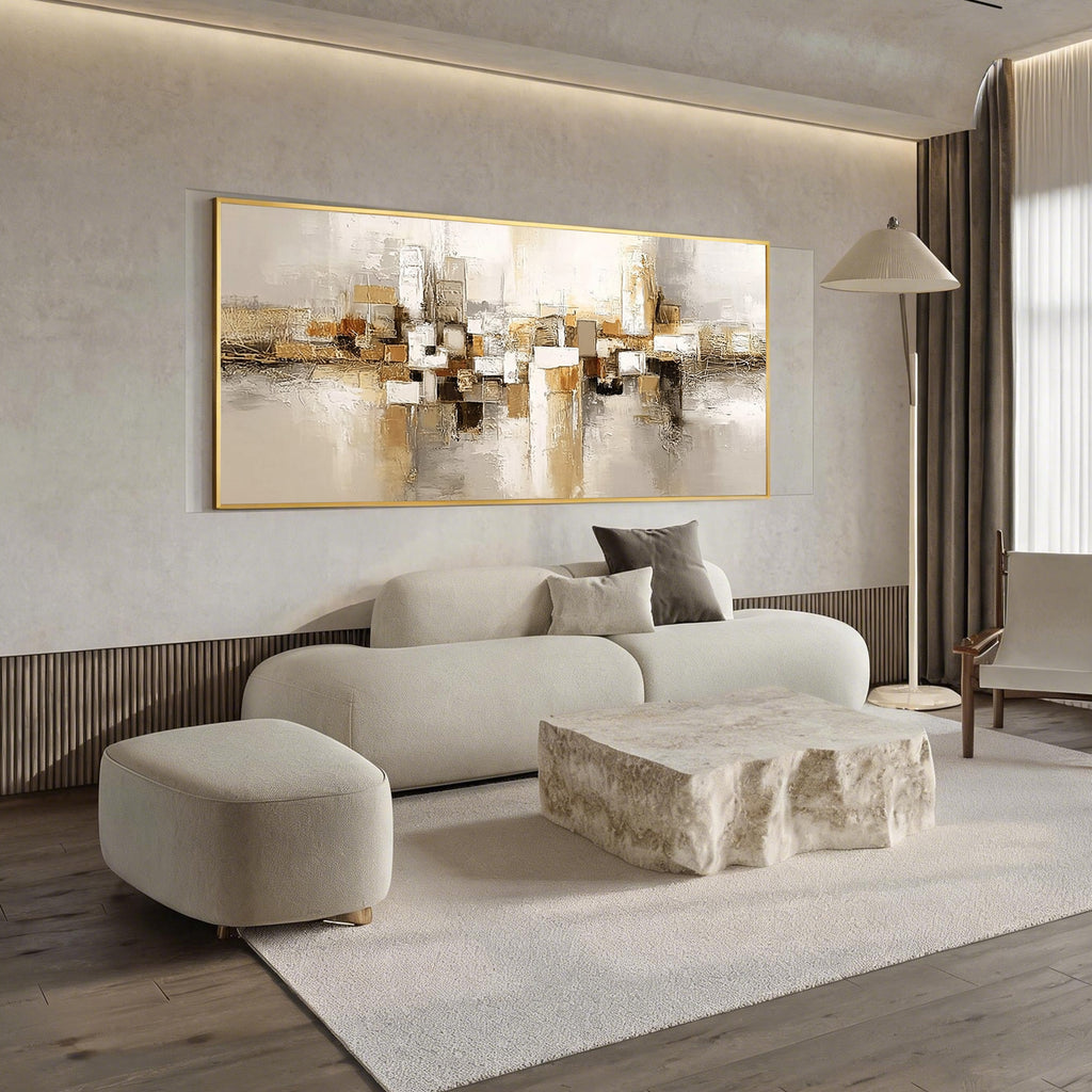 Beige gold abstract wall art with gold frame displayed in a modern living room, horizontal textured canvas painting with neutral tones and luxury contemporary home decor style