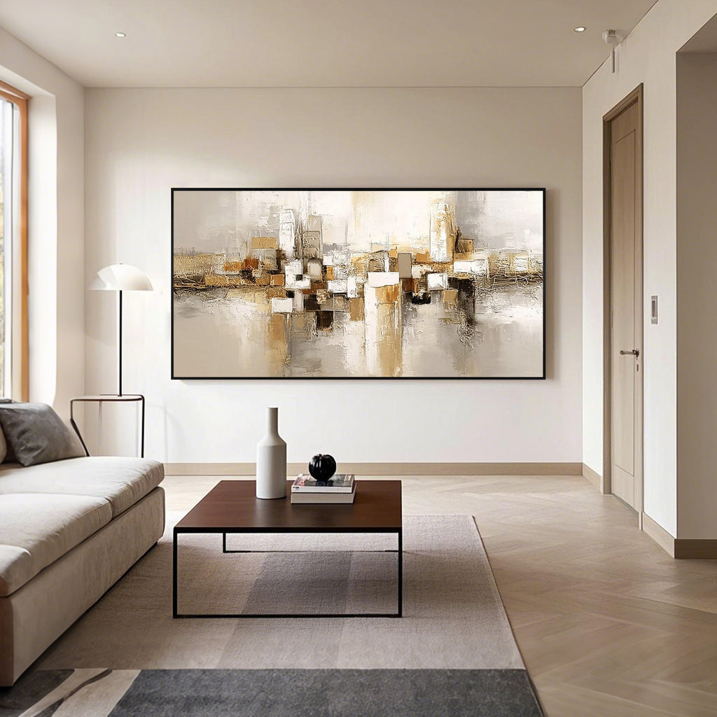 Beige gold geometric abstract wall art with black frame in a modern living room, horizontal textured canvas painting with neutral tones and contemporary home decor style