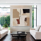 Beige textured abstract wall art displayed in a modern living room with minimalist furniture and natural light