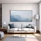 Modern blue textured abstract wall art painting displayed above a living room sofa for contemporary home decor