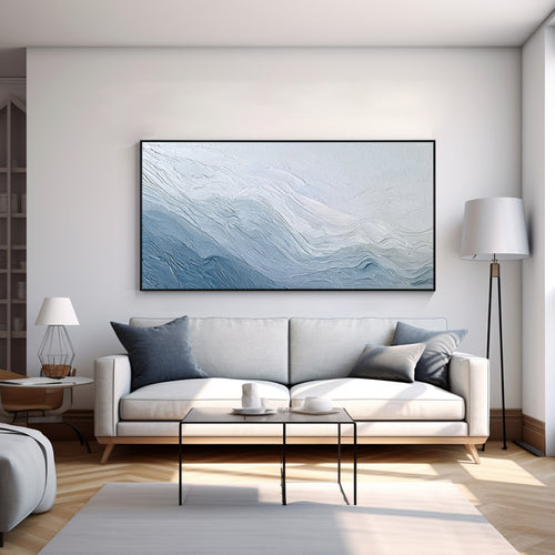 Modern blue textured abstract wall art painting displayed above a living room sofa for contemporary home decor
