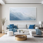 Blue and white textured abstract wall art painting displayed in a modern living room above a sofa