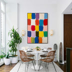 Colorful block abstract wall art with black frame displayed in a modern dining room, featuring vibrant color squares, textured brush strokes and contemporary interior decor