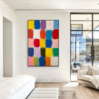 Colorful block abstract wall art with black frame displayed in a modern entryway, featuring vibrant color squares, textured brush strokes and contemporary home decor style