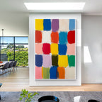 Colorful block abstract wall art with white frame displayed in a modern interior, featuring vibrant color squares, textured brush strokes and contemporary home decor style
