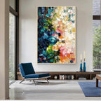 Colorful blue green pink and orange textured abstract wall art with gold frame displayed in a modern living room, featuring layered brush strokes and contemporary interior design
