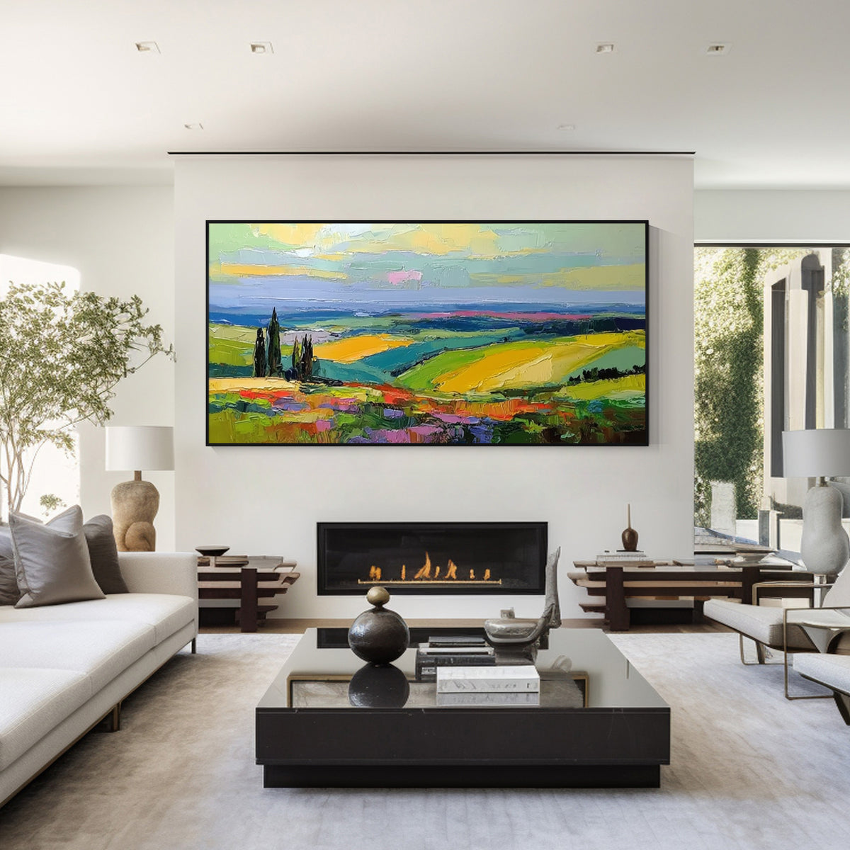 Colorful countryside landscape wall art with black frame above a fireplace in a modern living room