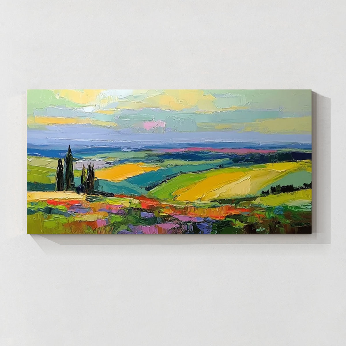 Colorful countryside landscape canvas wall art featuring green fields, yellow hills, blue sky and vibrant textured brushwork