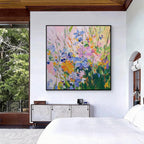 Colorful floral abstract painting with black frame displayed in a modern bedroom interior