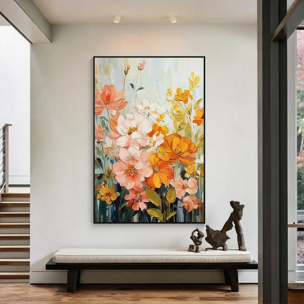 Colorful floral wall art with pink, orange and yellow flowers in a black frame above an entryway bench in a modern home