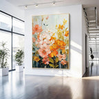 Colorful floral wall art with pink, orange and yellow flowers in a gold frame in a modern entryway