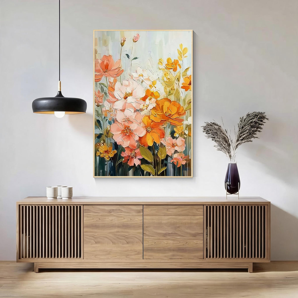 Colorful floral wall art featuring peach pink and golden yellow flowers in a gold frame, displayed above a wooden sideboard in a modern minimalist living room.