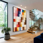 Colorful geometric textured abstract wall art with black frame displayed in a modern interior, featuring multicolor blocks, layered paint texture and contemporary home decor style