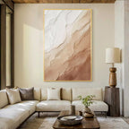 Cream beige textured abstract wall art with gold frame, minimalist plaster style painting displayed in a modern living room