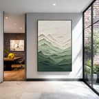 Green gradient textured abstract wall art with black frame displayed in a modern interior