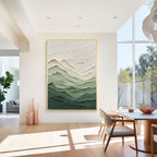 Green gradient textured abstract wall art with gold frame displayed in a modern living room interior