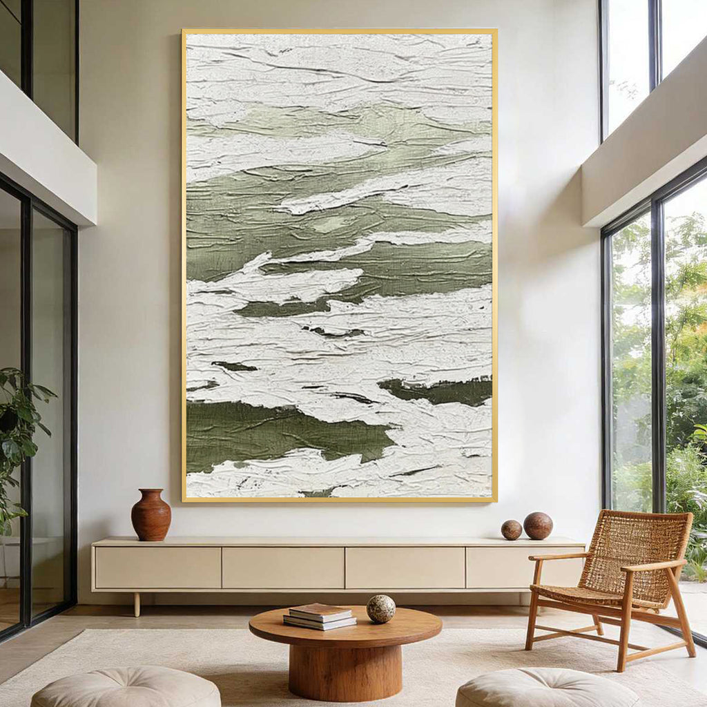 Green and white textured abstract wall art with gold frame displayed in a modern living room, featuring layered organic patterns and minimalist contemporary interior design