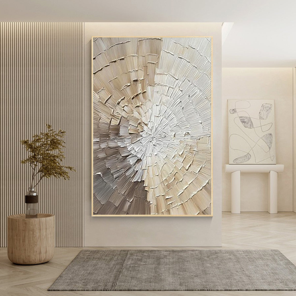 Ivory textured circular abstract art with gold frame displayed in a modern entryway, sculptural plaster wall decor with raised texture