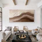 Large 3D textured abstract wall art with beige and brown layered relief design displayed in a modern minimalist living room, framed canvas artwork for luxury home decor