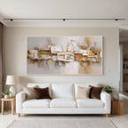Layered relief textured abstract wall art with gold frame above a white sofa in a modern living room