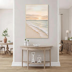 Minimal coastal ocean painting with gold frame displayed in a bright modern entryway interior