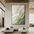 Modern green and beige textured abstract wall art with black frame displayed in a spacious living room, featuring layered organic patterns and minimalist design
