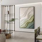 Modern green and beige textured abstract wall art with black frame displayed in a minimalist interior, featuring layered organic patterns and contemporary design