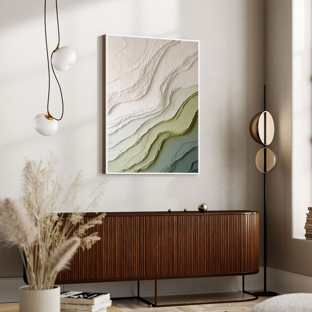 Modern green and beige textured abstract wall art with white frame featuring layered organic patterns displayed in a minimalist interior