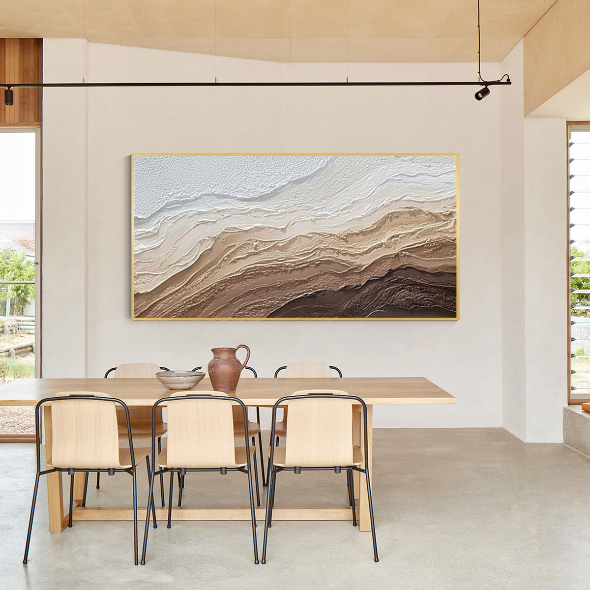 Modern abstract textured wall art with light wood frame displayed in a minimalist dining room, neutral beige and brown canvas artwork for home decor