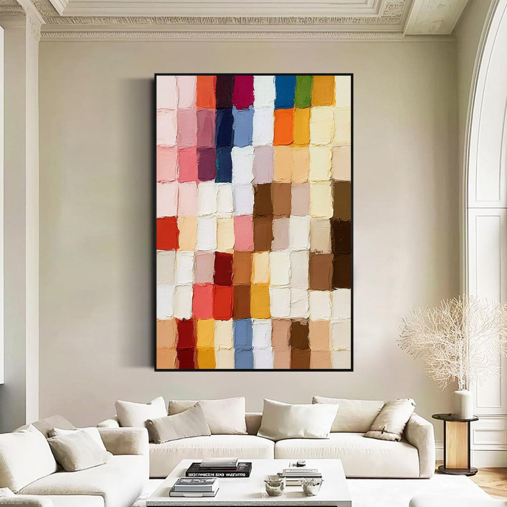 Multicolor block textured abstract painting with black frame displayed in a bright modern living room, featuring layered paint texture and contemporary wall decor style