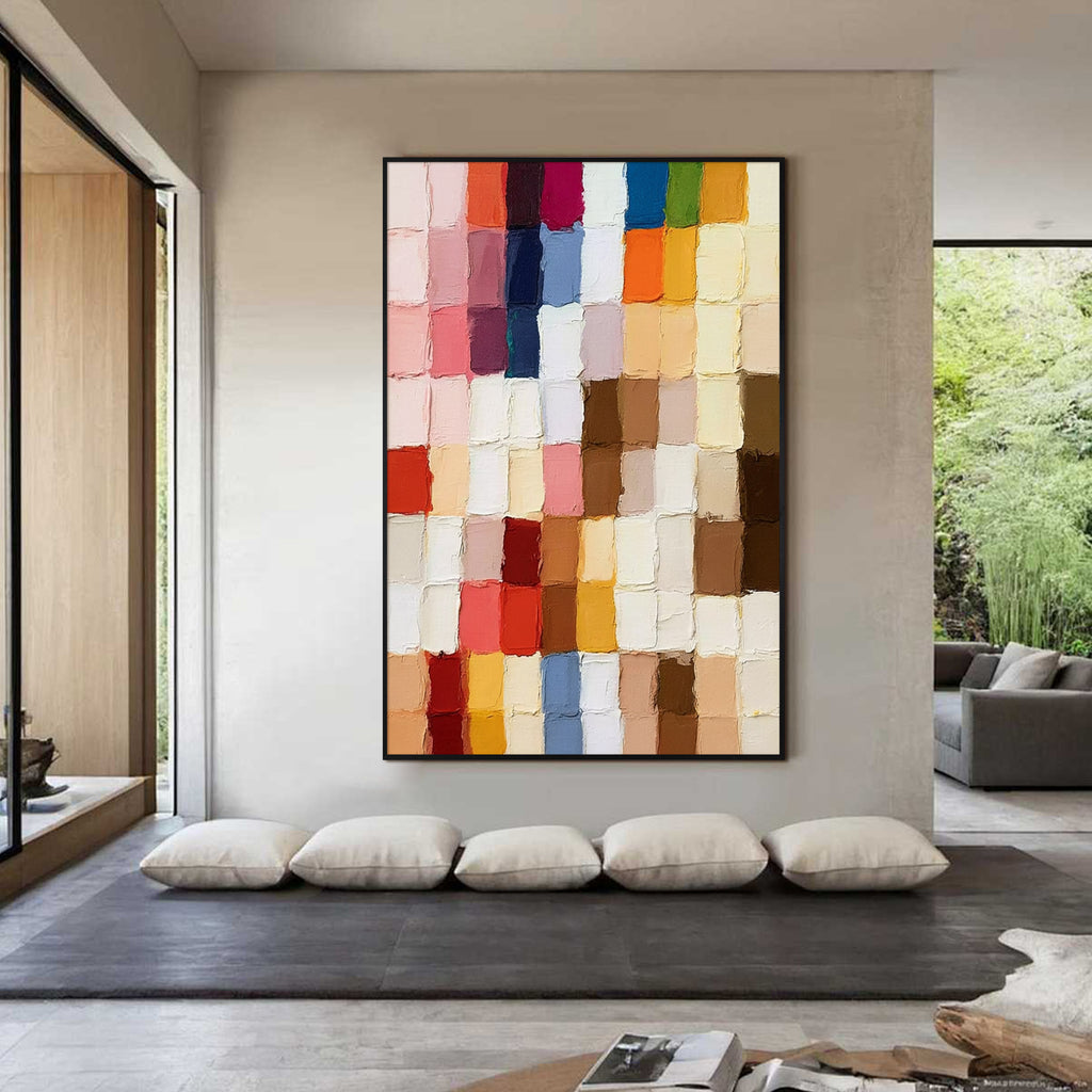 Multicolor geometric textured abstract wall painting with black frame displayed in a modern minimalist interior, featuring layered paint blocks and contemporary decor style