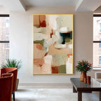 Neutral abstract painting with gold frame displayed in a modern living room, beige green and brown wall art decor