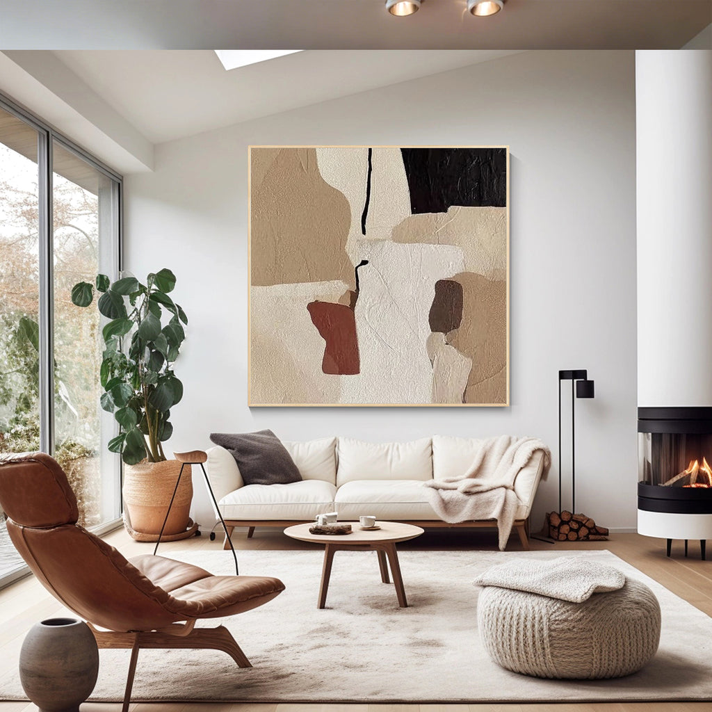 Neutral abstract wall art displayed above a modern living room sofa with minimalist interior decor