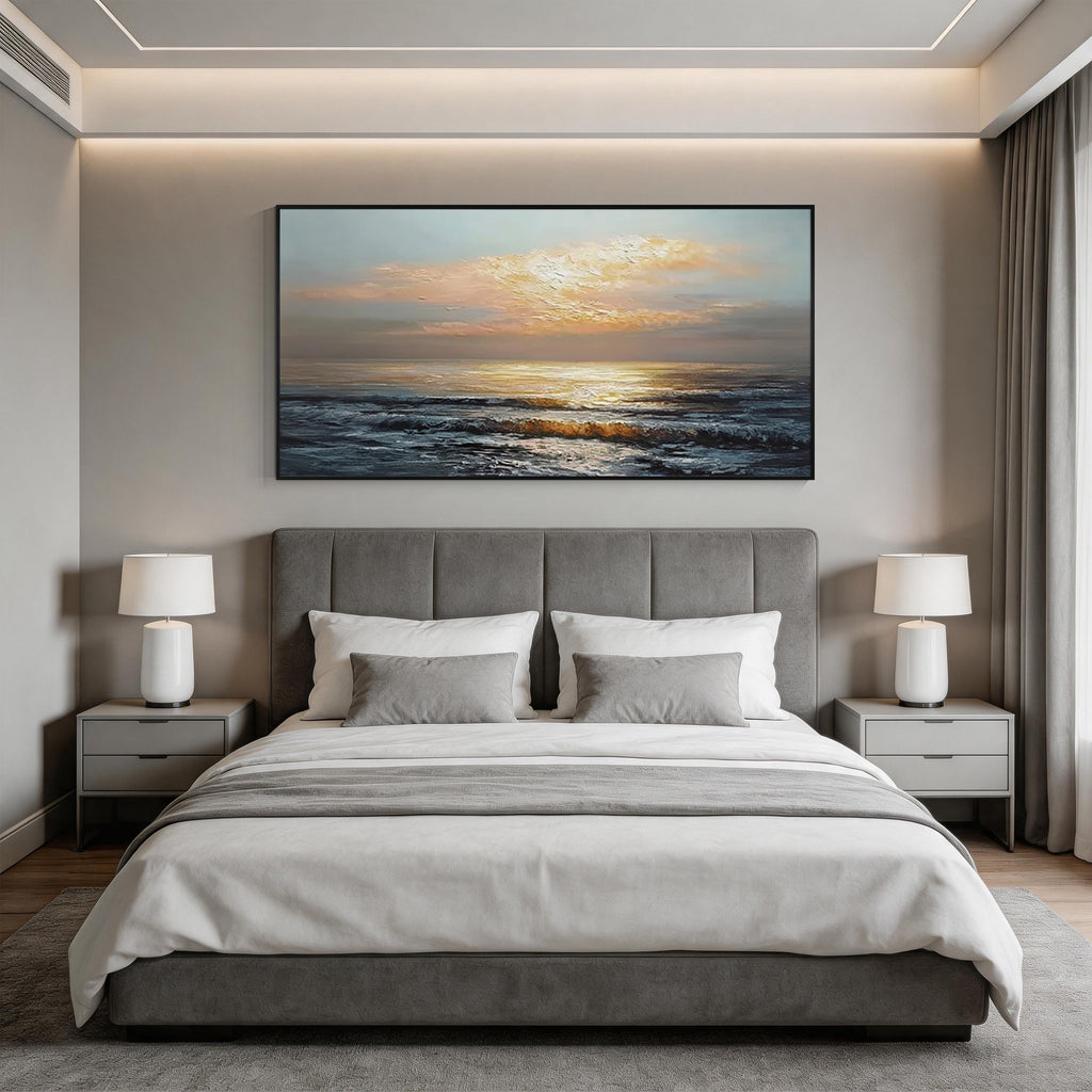 Sunset ocean wall art with black frame displayed above the bed in a modern bedroom, featuring golden sunlight and textured ocean waves