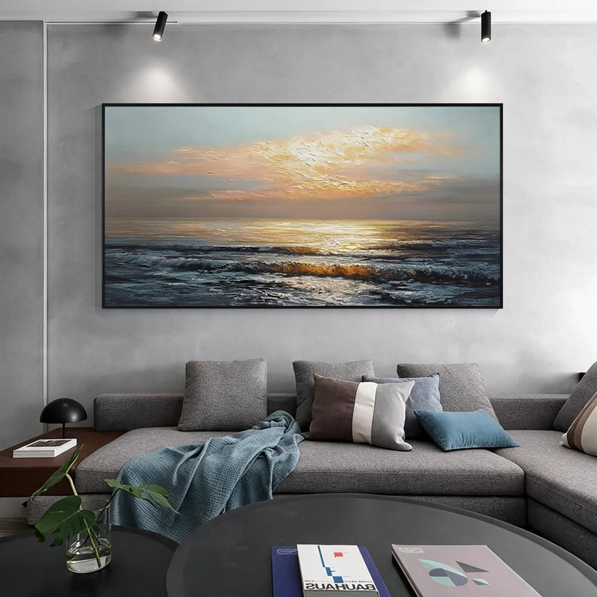 Sunset ocean wall art with black frame displayed above a sofa in a modern living room, featuring golden sunlight and textured ocean waves