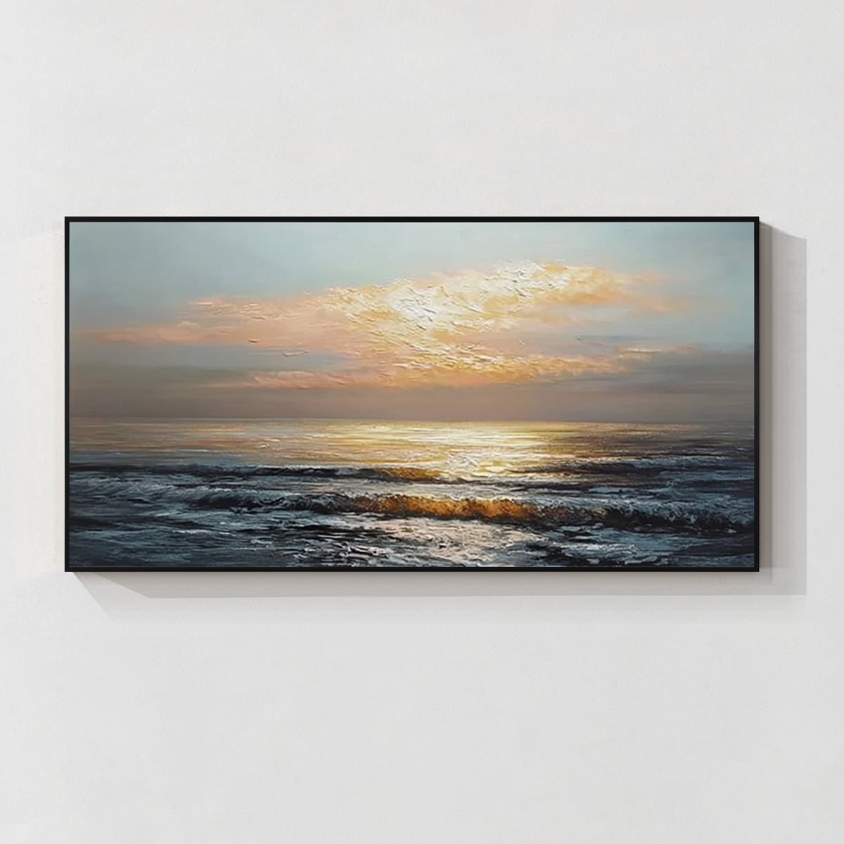 Sunset ocean wall art with black frame, featuring golden sunlight over waves in a modern coastal style