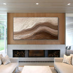 3D textured abstract wall art with layered beige and brown relief design displayed above a fireplace in a modern luxury living room, framed canvas artwork for home decor