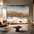 Textured ocean wave and beach wall art with black frame in a modern minimalist entryway