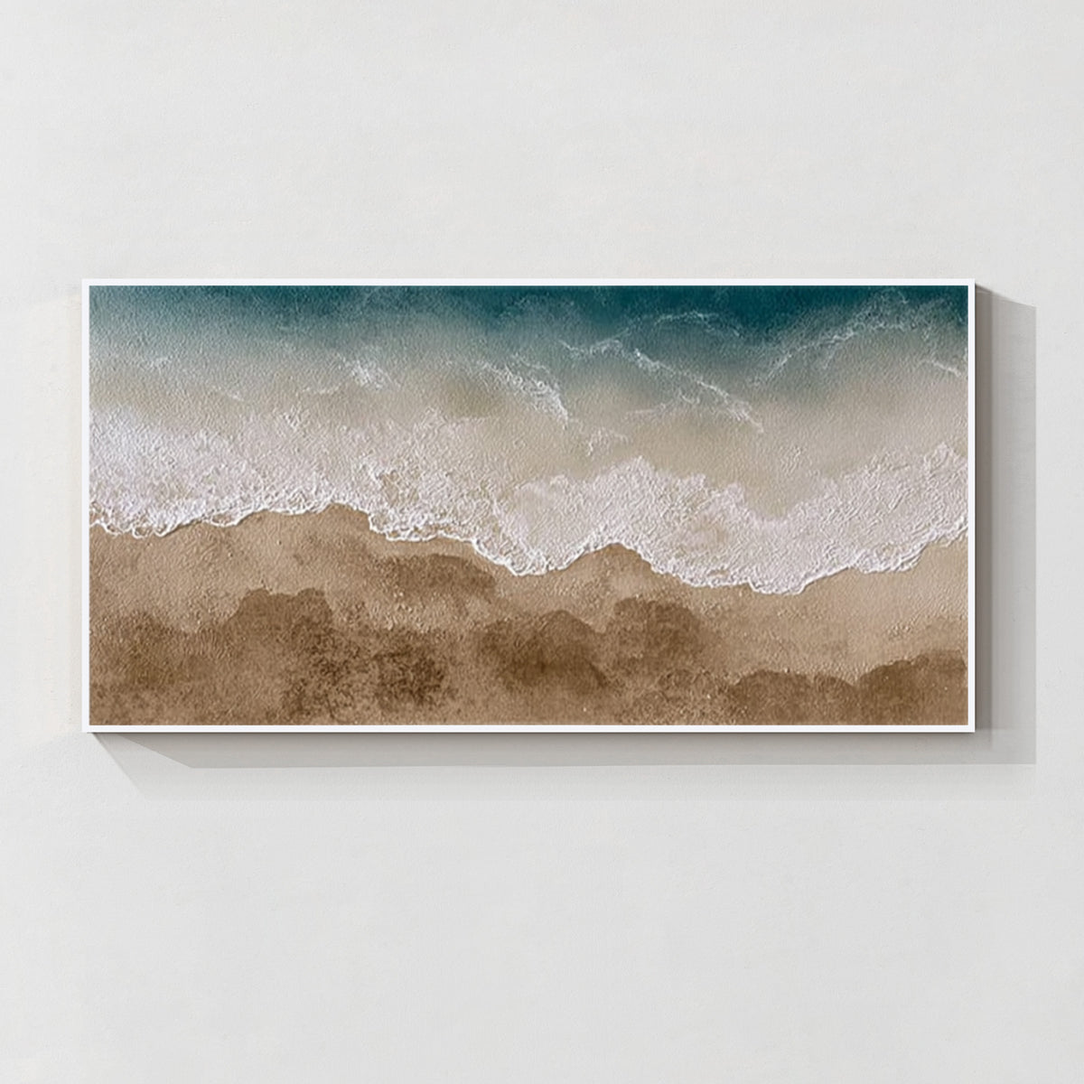Textured ocean wave and beach wall art with white frame in teal blue and sandy beige tones